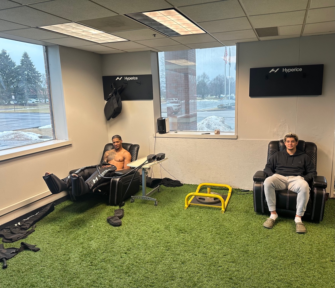 Athletes in Normatec compression boots